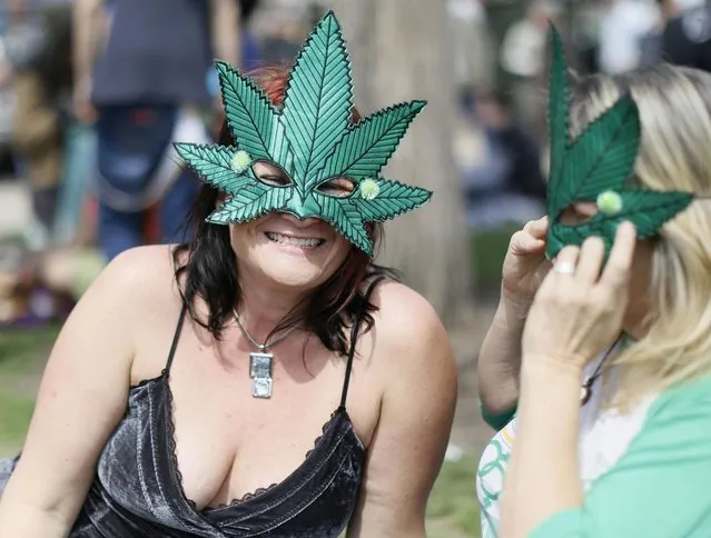 Women wearing marijuana leaf masks smile at the 4/20 marijuana holiday in Civic Center Park in downtown Denver April 20, 2013. Thousands of marijuana enthusiasts gathered in Denver on Saturday for an annual weekend celebration of cannabis, the first such assemblage since Colorado voters legalized the recreational use of pot last fall. (Photo by Rick Wilking/Reuters)