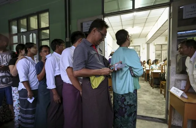 People line up to cast their votes for the general election at a polling station in Yangon November 8, 2015. Voting began on Sunday in Myanmar's first free nationwide election in 25 years, the Southeast Asian nation's biggest stride yet in a journey to democracy from dictatorship. (Photo by Soe Zeya Tun/Reuters)