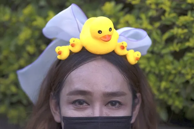 A protester wears a head band designed with yellow ducks, which have become good-humored symbols of resistance during anti-government rallies, on Wednesday, November 25, 2020, in Bangkok Thailand. (Photo by Wason Wanichakorn/AP Photo)