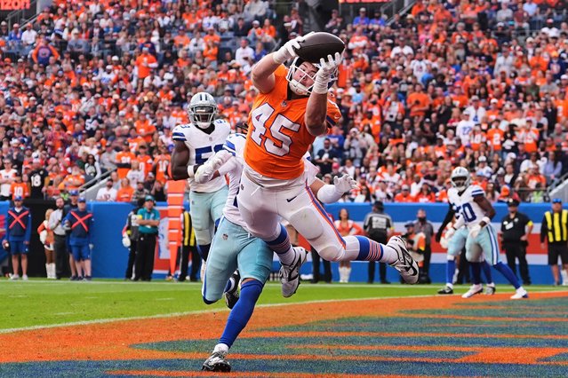Denver Broncos tight end Nate Adkins (45) makes a diving attempt to catch an incomplete pass as Dallas Cowboys' Reddy Steward, rear, defends in the second half of an NFL football game Sunday, October 26, 2025, in Denver. (Photo by David Zalubowski/AP Photo)