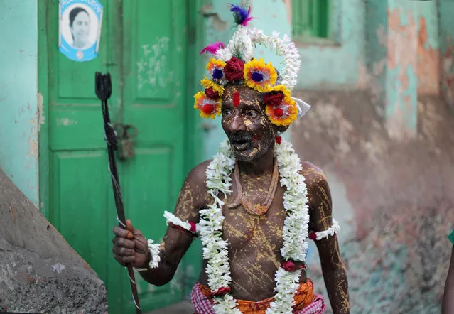 A Hindu holy man dressed as Lord Shiva participates in a religious procession during the Gajan festival in Kolkata, India, 13 April 2023. The Hindu festival runs for a month, ending with the beginning of the Bengali New Year in April, and celebrates the union of the sun and the earth. (Photo by Piyal Adhikar/EPA/EFE/Rex Features/Shutterstock)