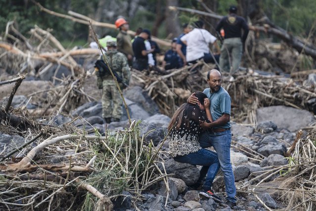 Relatives of police officer Jorge Alberto Ladrón de Guevara react as rescuers recover his body in Alto Lucero, Veracruz, Mexico, Tuesday, July 2, 2024. State authorities said he died in a car accident while checking damage caused by heavy rain. (Photo by Felix Marquez/AP Photo)