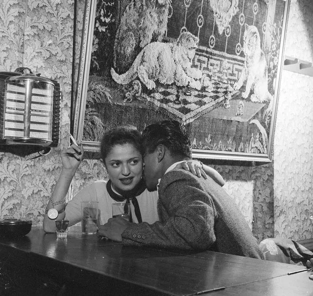1956:  A client gets acquainted with a prostitute at a bar in Guatemala City, capital of Guatemala.  (Photo by Evans/Three Lions/Getty Images)