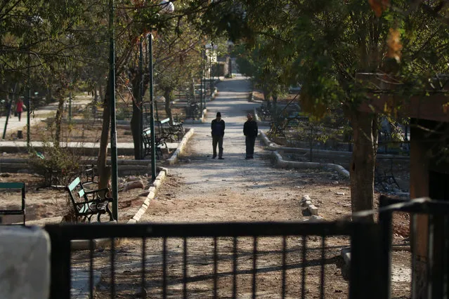 Men walk in a public park in a rebel-held besieged area in Aleppo, Syria November 6, 2016. (Photo by Abdalrhman Ismail/Reuters)