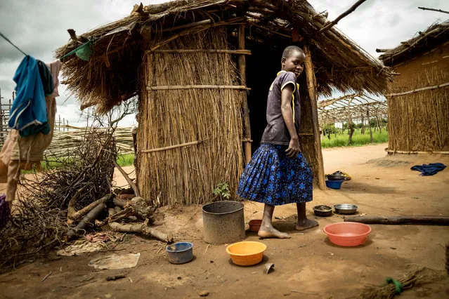 A child outside a home in the village. (Photo by David Levene/The Guardian)
