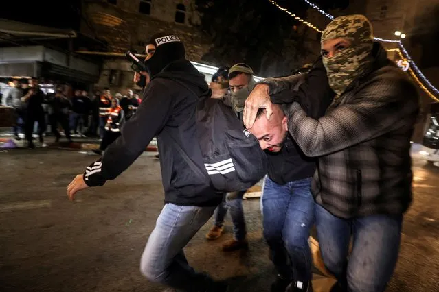 Israeli undercover police force detain a protester during clashes between Israeli security forces and Palestinians at Damascus Gate by the entrance to Jerusalem's Old City on April 3, 2022. (Photo by Ammar Awad/Reuters)