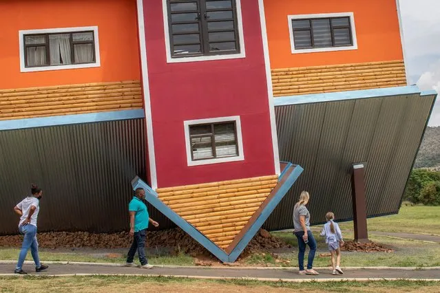 Tourists walk around the “Upside down house” tourist attraction near Johannesburg, South Africa, 04 November 2020. The newly build tourist attraction is a first for South Africa and appears to be a house build upside down and features rooms within the house that are also upside down, creating a unique and mind shifting experience. (Photo by Kim Ludbrook/EPA/EFE)