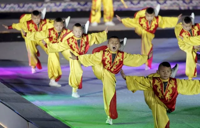 Boys perform Chinese Kung Fu to celebrate the new year during a countdown event at Tai Miao, the imperial ancestral temple in the Forbidden City, in Beijing, China, December 31, 2015. (Photo by Jason Lee/Reuters)