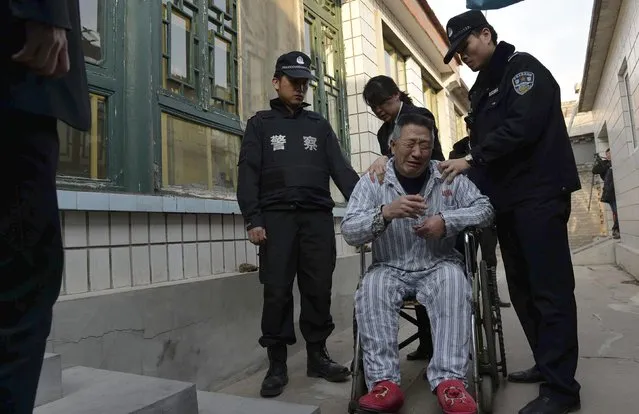 A man cries in front of his home as policemen enforce a court order to remove him from a hospital in Beijing February 10, 2015. (Photo by Reuters/Stringer)