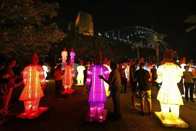 Members of the public stand and walk next to an art installation called the “Lanterns of the Terracotta Warriors” in front of the Sydney Harbour Bridge February 19, 2015. The more than two-meter (7 feet) high lanterns, shaped in the form of China's famous terracotta warriors that were unearthed in 1974, are on display as part of Sydney's Chinese Lunar New Year Festival. (Photo by David Gray/Reuters)