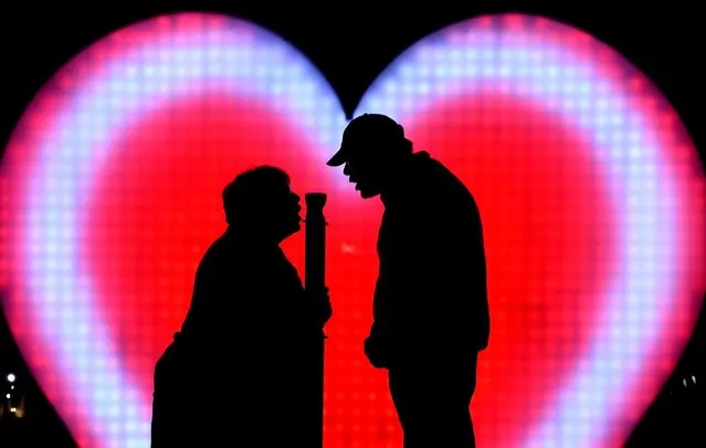 A couple shout I love you at the I Love You (AUS) installation at First Fleet Park as part of the Vivid Sydney festival of light in Sydney, Australia, 26 May 2016. (Photo by Dean Lewins/EPA)