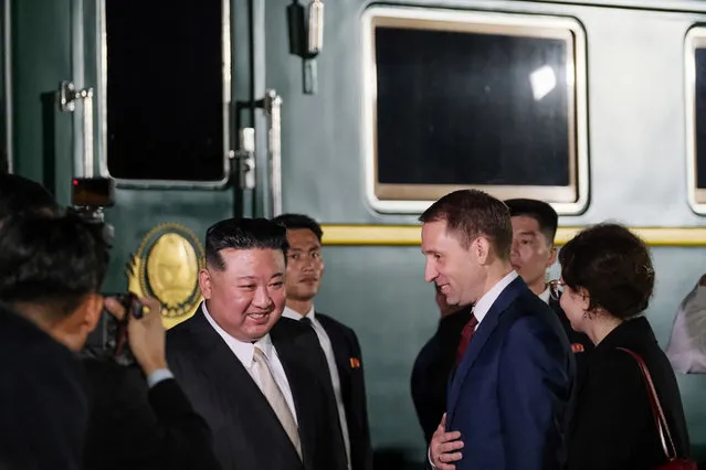 This handout photograph taken and released by Ministry of Natural Resources and Environment of Russia on September 12, 2023, shows North Korea's leader Kim Jong Un (C,L) welcomed by Russia's Minister of Natural Resources and Environment Alexander Kozlov (C,R) upon his arrival at Khasan train station, Primorky region, at the start of his official visit to Russia. North Korean leader Kim Jong Un arrived in Russia on September 12, 2023 ahead of a meeting with President Vladimir Putin that the United States has warned could see an arms deal to support Moscow's assault on Ukraine. (Photo by Handout/Russian Environment Ministry/AFP Photo)