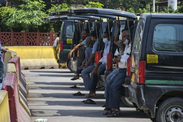 Cab drivers await passengers outside the New Delhi railway station in New Delhi, India, Monday, June 7, 2021. (Photo by Ishant Chauhan/AP Photo)