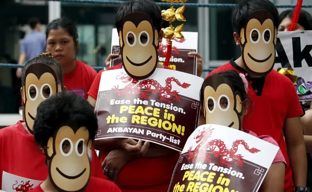 Activists from the Akbayan Party list group wear monkey cardboard masks, symbolising the Year of the Monkey in Chinese lunar calendar, during a protest rally outside the Chinese Consulate in Makati city, Metro Manila, February 5, 2016. In a statement by the activists, the Akbayan group trooped to the Chinese consular office to commemorate Lunar New Year while calling out the Chinese government for its continued incursions into Philippine territories. (Photo by Erik De Castro/Reuters)