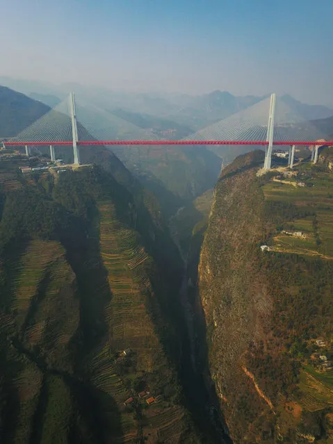 This picture taken on December 28, 2016 shows the Beipanjiang Bridge, near Bijie in southwest China's Guizhou province. The world's highest bridge has opened to traffic in China, connecting two southwestern provinces and reducing travel time by three quarters, local authorities said on December 30. (Photo by AFP Photo/Stringer)