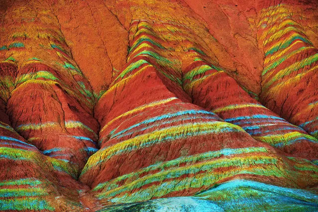 View of colourful rock formations at the Zhangye Danxia Landform Geological Park in Gansu Province, China. The Zhangye Danxia Landform Geological Park is 40km from Zhangye city. The park spans more than 400 square kilometers in Gansu. The unusual terrain is the result of red sandstone and mineral deposits carved over the years by natural forces. A number of boardwalks have been built to encourage visitors to explore the rock formations. (Photo by ImagineChina/The Grosby Group)