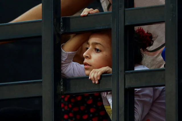 A girl looks on as Palestinians flee north Gaza to move southward, in the central Gaza Strip on November 12, 2023. (Photo by Ibraheem Abu Mustafa/Reuters)