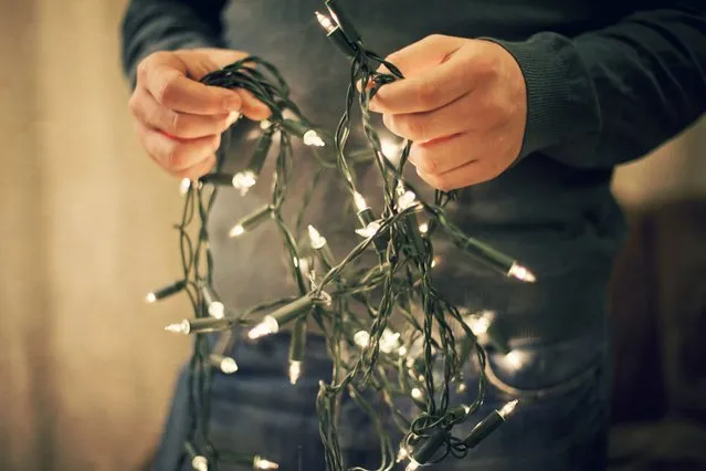 Textured picture of man holding fairy lights. (Photo by Sally Anscombe/Getty Images)