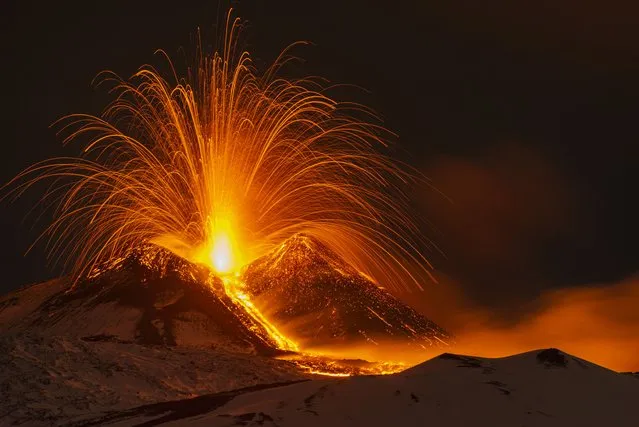 Lava erupts from Southeast crater on Mount Etna seen from Nicolosi near Catania, late evening Friday, December 1, 2023. (Photo by Salvatore Allegra/AP Photo)