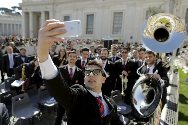 A musician takes a selfie with others members of his band during Pope Francis' Wednesday general audience in Saint Peter's Square at the Vatican April 8, 2015. (Photo by Tony Gentile/Reuters)