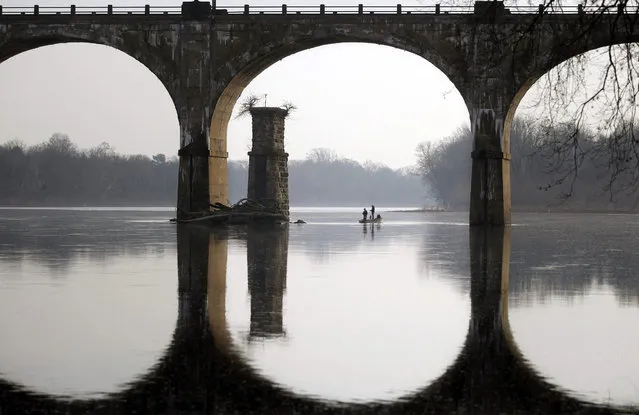 People take advantage of unseasonably warm weather to fish on the Delaware River Sunday, December 13, 2015, near Yardley, Pa. (Photo by Mel Evans/AP Photo)