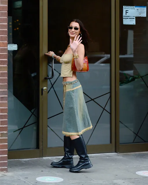 Bella Hadid is all smiles as she steps out in New York City on September 1, 2021. The 24 year old supermodel wore a green tank top, denim skirt, and knee high black boots. (Photo by The Image Direct)