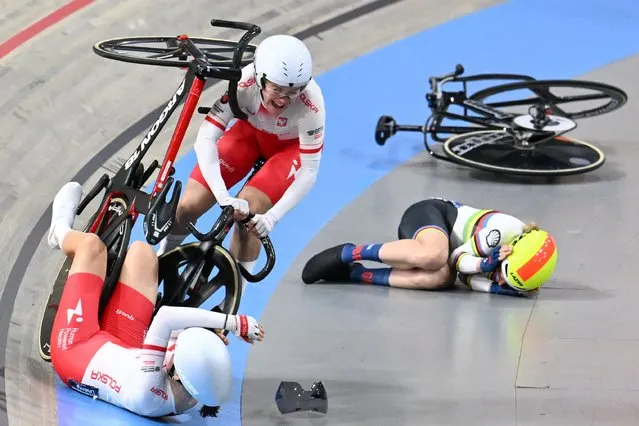 Poland's Daria Pikulik, Poland's Wiktoria Pikulik and Britain's Elinor Barker (R) crash as they compete in the Women's Madison race during the fifth day of the UEC European Track Cycling Championships at the Omnisport indoor arena in Apeldoorn, on January 14, 2024. bark (Photo by John Thys/AFP Photo)