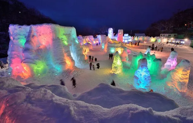 People visit the Chitose-Lake Shikotsu Ice Festival illuminated by colorful light to produce a fantastic world in Chitose on January 24, 2014. The annual ice festival will be held until February 16. (Photo by Kazuhiro Nogi/AFP Photo)