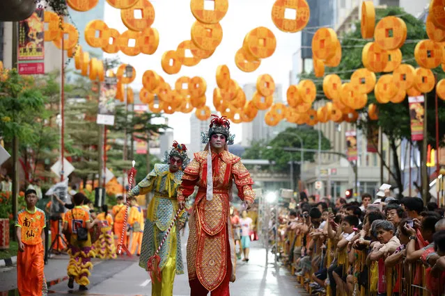 Entertainers on stilt walkers entertain the crowd during the Chinese New Year Celebrations 2014 Official Light-Up and Opening Ceremony in Chinatown on January 11, 2014 in Singapore. (Photo by Suhaimi Abdullah/Getty Images)