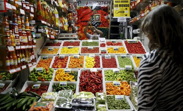 A woman looks at chillies and peppers at a market in Belo Horizonte, Brazil in this June 30, 2014 file photo. (Photo by Toru Hanai/Reuters)