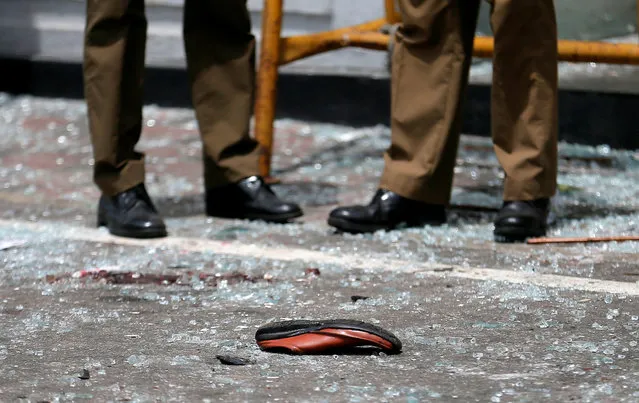A shoe of a victim is seen in front of the St. Anthony's Shrine, Kochchikade church after an explosion in Colombo, Sri Lanka April 21, 2019. (Photo by Dinuka Liyanawatte/Reuters)