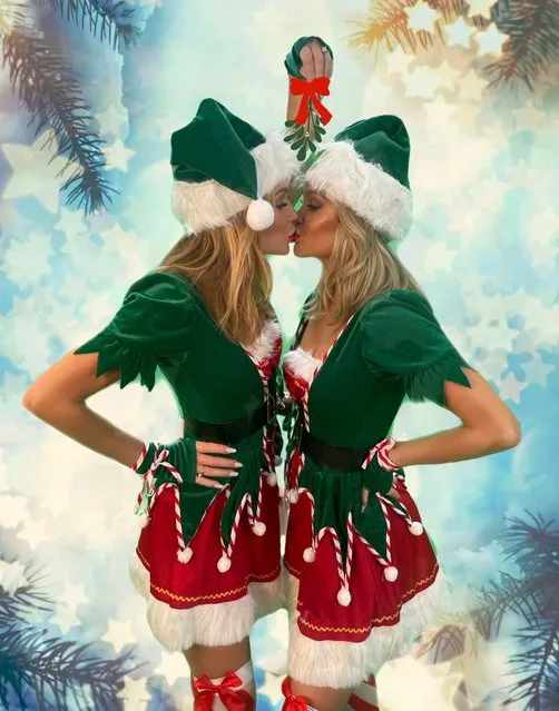 UK radio presenters Amanda Holden and Ashley Roberts are both naughty and nice as they share a cheeky Christmas smooch underneath the mistletoe in November 2021. Amanda, 50, and Ashley, 40, first kissed on camera two years ago on social media. (Photo by Christian Vermaak/The Sun)