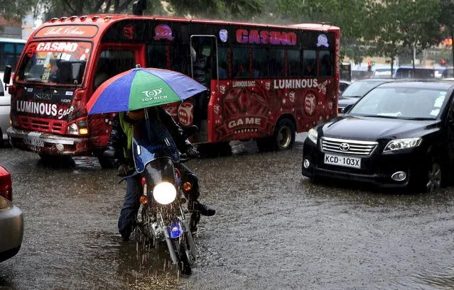 A motorcyclist wades through water during heavy rains in Kenya's capital Nairobi March 9, 2016. (Photo by Noor Khamis/Reuters)