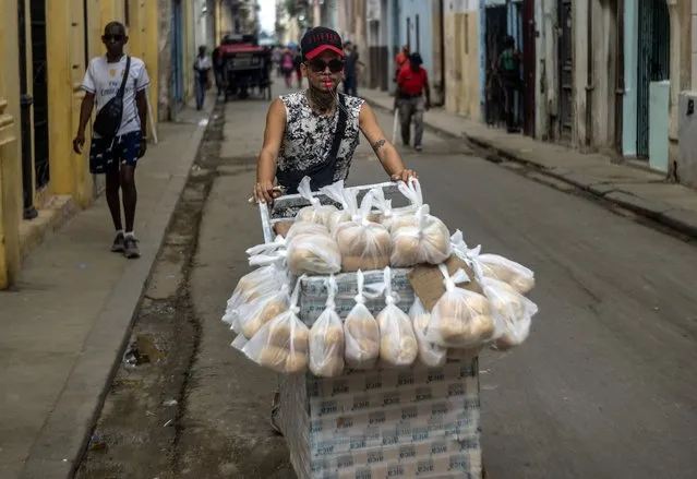 A bread vendor pushes his cart down a street, in Havana, Cuba, Tuesday, January 9, 2024. (Photo by Ramon Espinosa/AP Photo)