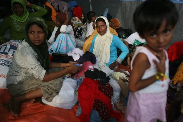 Ethnic Rohingya women sit inside a tent in Langsa, Aceh province, Indonesia, Saturday, May 16, 2015. (Photo by Binsar Bakkara/AP Photo)