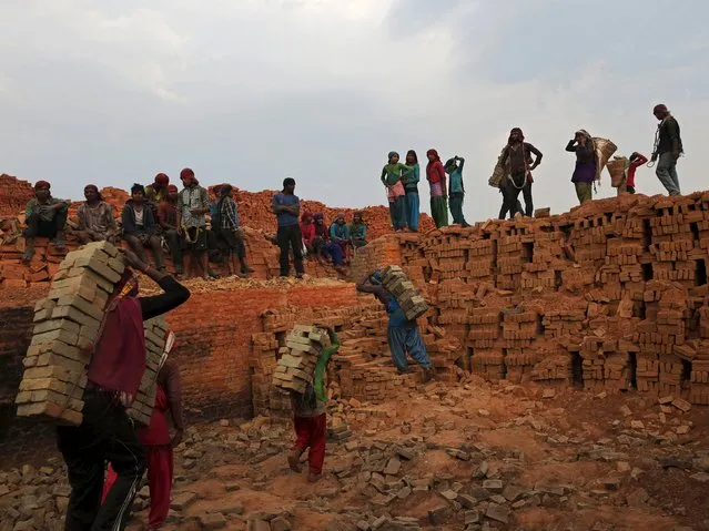 Men and women work at a brick factory in Bhaktapur, Nepal, May 17, 2015. (Photo by Ahmad Masood/Reuters)