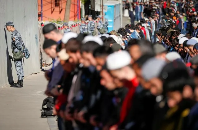 Members of Russia's National Guard line up as Muslims attend the morning prayers of Eid al-Fitr, marking the end of the holy month of Ramadan, in Moscow, Russia on June 4, 2019. (Photo by Shamil Zhumatov/Reuters)