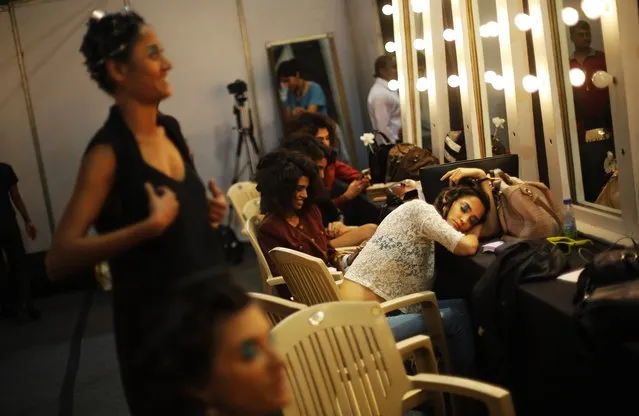 Models take break backstage on the final day of the Wills Lifestyle India Fashion Week in New Delhi, India, Sunday, March 30, 2014. (Photo by Altaf Qadri/AP Photo)