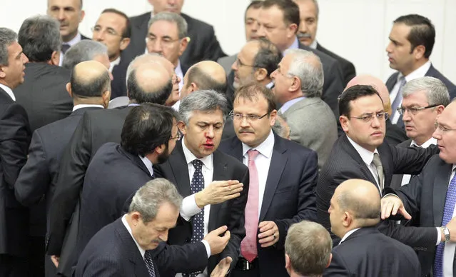 Member of parliament (MP) from the main opposition Republican People's Party (CHP) Ali Ihsan Kokturk's nose bleeds as MPs from the ruling AK Party (AKP) and CHP scuffle during a debate on a draft law which will give the government tighter control over the appointment of judges and prosecutors, at a parliamentary session in Ankara early February 15, 2014. (Photo by Reuters/Stringer)