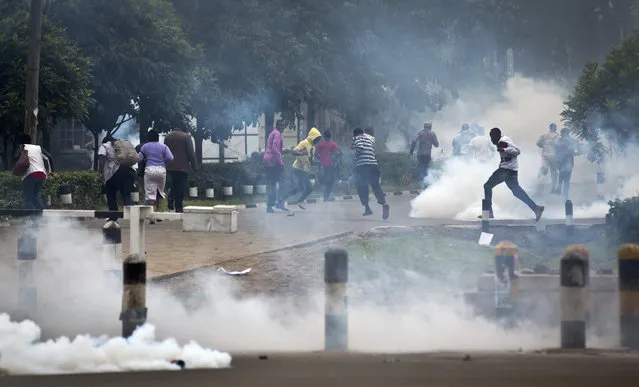 Opposition supporters run away from tear gas fired by riot police during a protest in downtown Nairobi, Kenya Monday, May 9, 2016. (Photo by Ben Curtis/AP Photo)