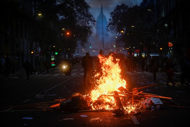 A fire burns during a protest near the National Congress, on the day Senators debate Argentina's President Javier Milei's economic reform bill, known as the “omnibus bill”, in Buenos Aires, Argentina, on June 12, 2024. (Photo by Mariana Nedelcu/Reuters)