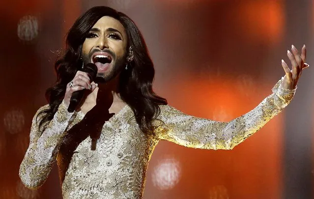Singer Conchita Wurst, representing Austria, performs the song “Rise Like a Phoenix” during a rehearsal for the second semifinal of the Eurovision Song Contest in the B&W Halls in Copenhagen, Denmark, on May 7, 2014. Wurst, also known by his birth-name Thomas Neuwirth, is challenging conceptions of masculine and feminine beauty, and seems to have stolen the limelight ahead of the televised extravaganza, with a potential worldwide audience of some 170 million viewers. (Photo by Frank Augstein/Associated Press)