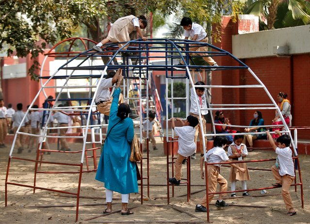 Students play during recess at a school after a majority of schools were reopened following their closure due to the coronavirus disease (COVID-19) pandemic, in Ahmedabad, India, February 25, 2022. (Photo by Amit Dave/Reuters)