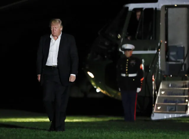President Donald Trump walks from Marine One across the South Lawn to the White House in Washington, Sunday, May 7, 2017, as he returns from Trump National Golf Club in Bedminster, N.J. (Photo by Carolyn Kaster/AP Photo)