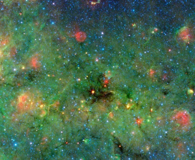 This NASA image obtained May 22, 2014 shows clumps that were discovered within a huge cosmic cloud of gas and dust. Infrared observations from NASA's Spitzer Space Telescope of these blackest-of-black regions in the cloud paradoxically light the way to understanding how the brightest stars form.The large cloud looms in the center of this image of the galactic plane from Spitzer. The zoom shows details of the cloud, revealing the dense clumps. (Photo by AFP Photo/NASA/University of Zurich)