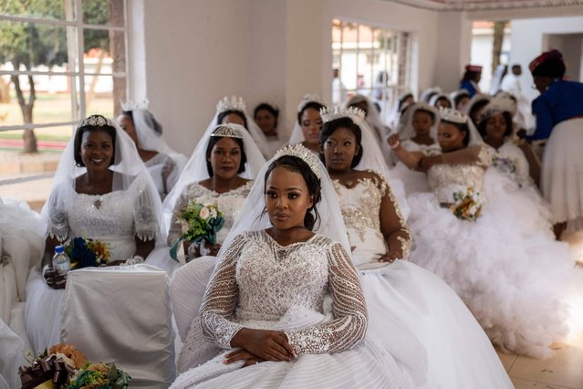 A group of brides are seen waiting at the International Pentecostal Holiness Church in Zuurbekom, south of Johannesburg, as they take part in a mass wedding ceremony where 80 couples got married during the Easter Sunday service on April 9, 2023. (Photo by Ihsaan Haffejee/AFP Photo)