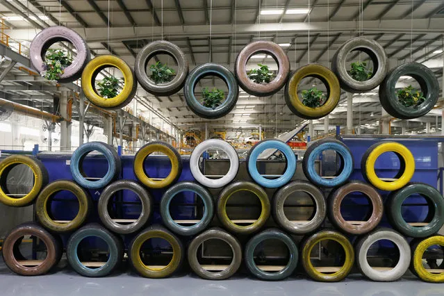 An installation built with spare tyres by BYD workers is displayed inside an assembly line of the automobile maker in Shenzhen, China May 25, 2016. (Photo by Bobby Yip/Reuters)