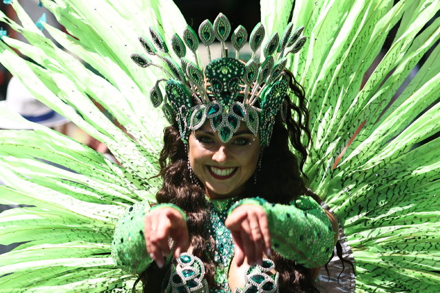 A dancer performs during the carnival of cultures in Berlin, Germany, 28 May 2023. Due to a three year break, caused by the coronavirus pandemic, the carnival of cultures celebrates its 25th anniversary this weekend. Various groups of different nationalities present dance and musical performances on moving floats. (Photo by Clemens Bilan/EPA)