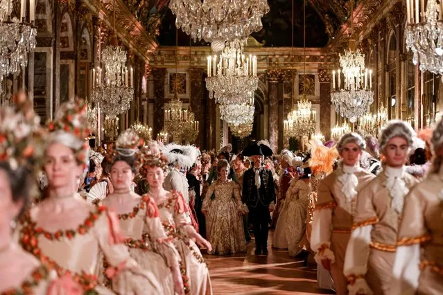 Guests wearing baroque style costumes take part in a ball in the Hall of Mirrors at the Chateau de Versailles Palace as part of the sixth edition's of the Fetes Galantes fancy dress evening which theme is the Royal Wedding of Marie Antoinette and Louis XVI, in Versailles on May 23, 2022. The annual fancy dress ball aims to re-create the baroque splendour of the Sun King's dazzling court feasts held to show off the wealth and power of France's longest-reigning monarch. For tickets costing more than five hundred euros, guests can wander through the private apartments of the chateau, which is a World Heritage site and one of France's biggest tourist attractions. (Photo by Ludovic Marin/AFP Photo)