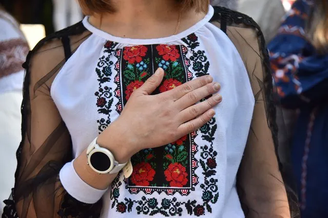 A woman wears a traditionally embroidered garment, as Ukrainians celebrate the Day of the Embroidered Shirt (Vyshyvanka), an integral part of the national Ukrainian costume, amid the Russian invasion in Ukraine, in Lviv, Ukraine on May 19, 2022. (Photo by Pavlo Palamarchuk/Reuters)